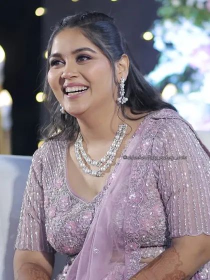 A joyful smile from the sangeet night. Her makeup is fresh and radiant, designed to look great in photos and in person.