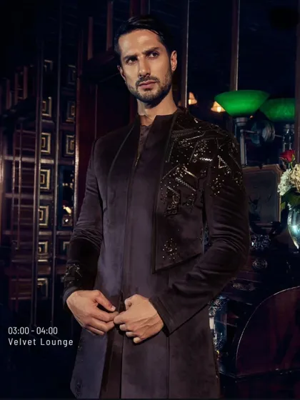 Another look at the deep wine velvet jacket. The asymmetrical embroidery on the shoulder adds a modern, artistic touch to a classic fabric.
