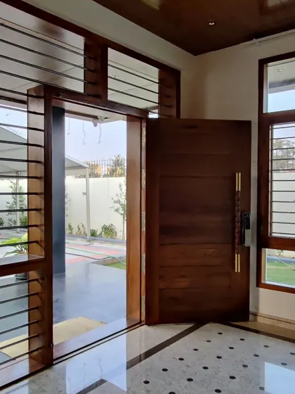 The wooden pivot door from the exterior, showing how it integrates with the building's facade.