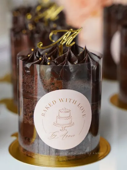 My mini cake tubs are perfect for party favors or individual indulgence. This one features layers of chocolate sponge and rich 54% Belgian dark chocolate ganache, topped with a custom initial.