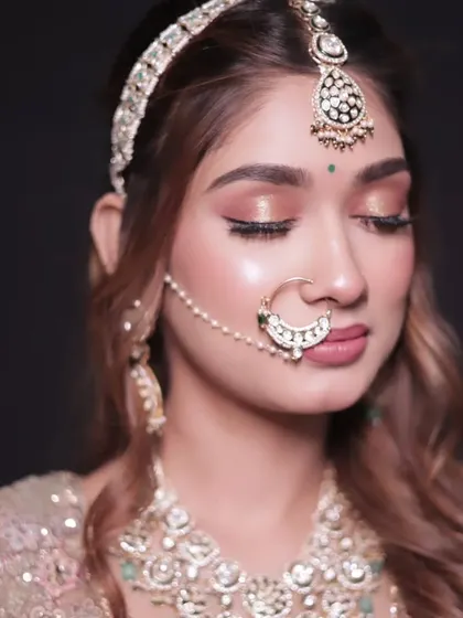 It's all in the details. We don't just rent outfits; we provide the complete look. This close-up shows our stunning bridal jewellery, including the maang tikka, nath, and necklace, all available to rent with your lehenga.