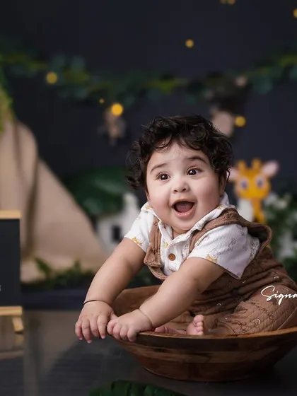 Another angle from the jungle-themed session, showcasing the complete setup and the baby's adorable outfit. These themed shoots are perfect for creating unique milestone memories.