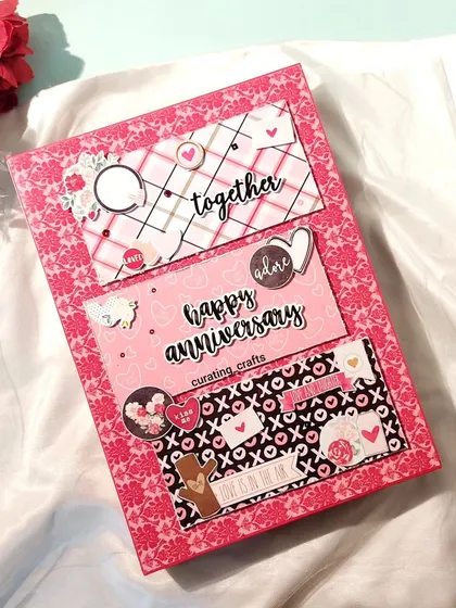 The cover of the A4 anniversary scrapbook, showing the intricate layering and personalized details.