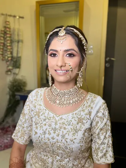 A close-up of the bride's soft glam makeup, with shimmery eyes and a natural pink lip.