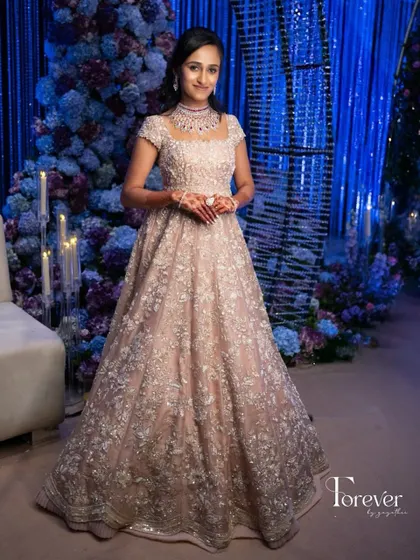A full-length view of the bride in her magnificent reception gown. My course teaches you to envision the entire look, ensuring the makeup and hair perfectly match the grandeur of the outfit.