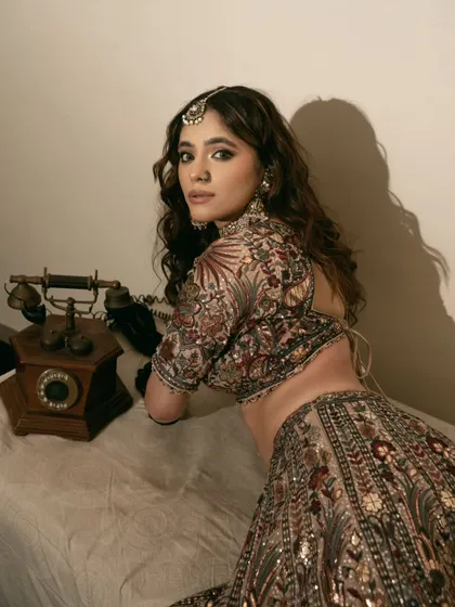 A vintage-inspired bridal portrait. The antique telephone prop and warm lighting create a nostalgic mood, perfect for a storytelling-based bridal portfolio.