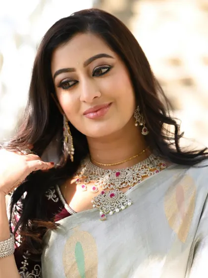 A throwback to this elegant look. The model is wearing a stunning American Diamond (AD) necklace set that mimics the look of real diamonds, perfect for a reception or cocktail party.