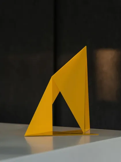 A minimalist shot of the "Yello" model, highlighting the beautiful interplay of light and shadow on its folded surfaces. This study helps us understand how the final sculpture will interact with the changing light of the sun throughout the day.