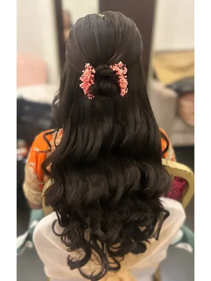 A clear, detailed shot of the half-updo with a twisted bun and loose curls, showing how the style looks from a different angle.
