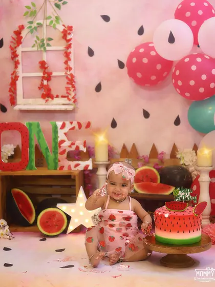 This little girl is enjoying every single moment of her special watermelon cake smash photoshoot.