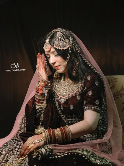 An emotional and serene portrait of a Muslim bride during her Nikah ceremony, capturing a moment of prayer or quiet reflection.