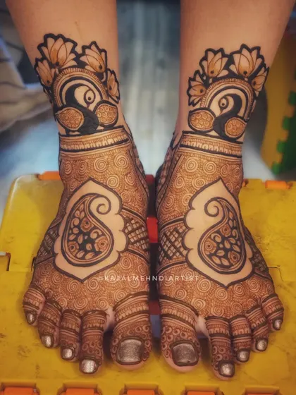 A beautiful foot design featuring large paisley motifs and peacocks on the ankles.