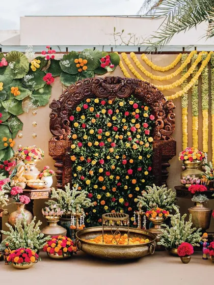 We brought traditional South Indian culture to life for this vibrant Haldi ceremony. The focal point is an antique wooden Prabhavali, framed by a wall of marigolds and tuberose, and complemented by authentic brassware, showing our deep appreciation for cultural details and heritage.