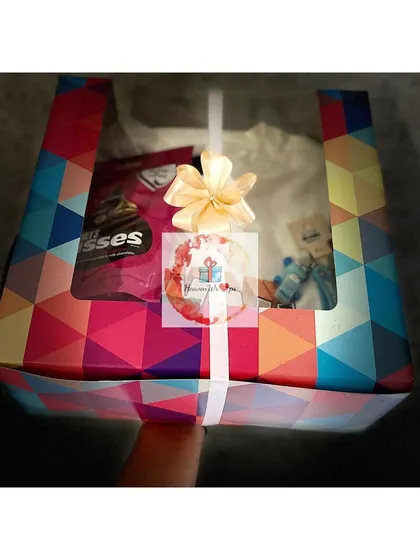 A colorful and modern gift box for him, containing chocolates and other surprises, perfect for any celebration.