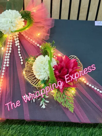 The finished surprise gift box, with its elegant floral and pearl decorations. The warm fairy lights make it perfect for an evening celebration.