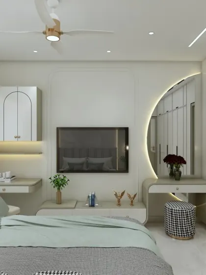 This bedroom features a multi-functional wall with an integrated TV unit, a study desk, and a beautiful arched dressing mirror with backlighting. It's a perfect example of how to maximize utility in a stylish way.