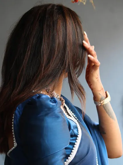 An artistic shot focusing on the back of the blouse and Sonu's beautiful hair.