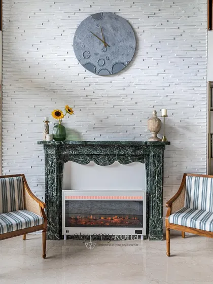 A close-up of the fireplace, showing the intricate carving on the green marble mantle. It’s a piece that adds both aesthetic value and warmth.