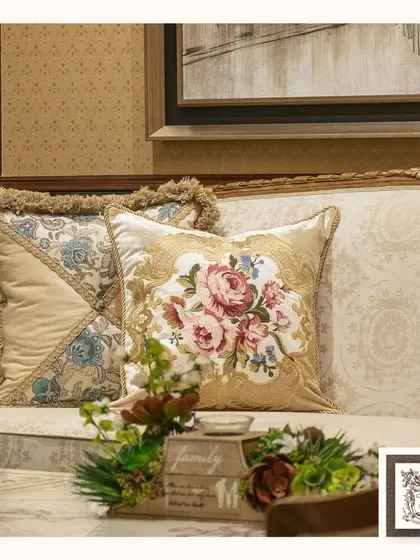 These floral fabric cushions add a layer of softness and traditional charm to a classic sofa. The intricate patterns and fringed edges are small details that contribute to a warm and inviting atmosphere.