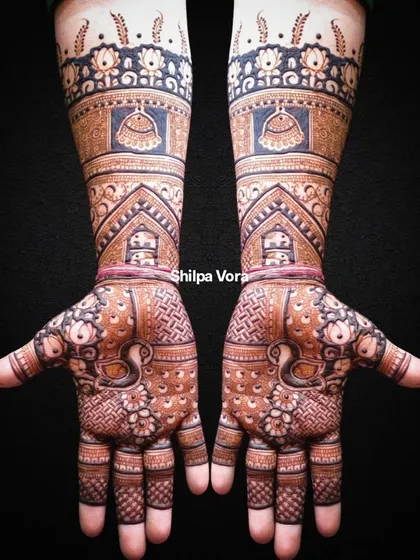 A black background makes the intricate details of this full-arm design stand out.
