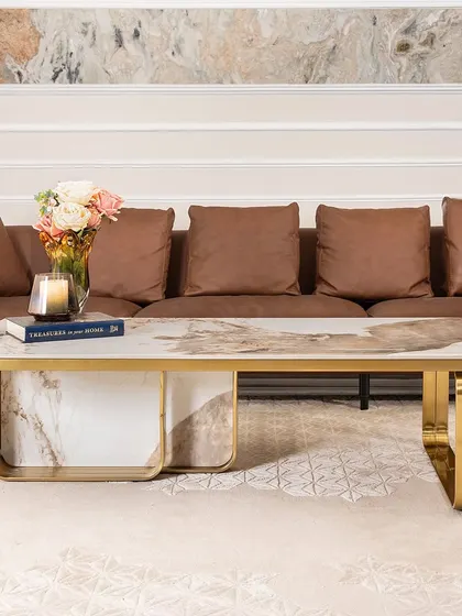 A closer look at the spectacular patterns in the artificial marble top of this rectangular coffee table. The gold-accented stainless steel frame provides a sturdy and luxurious foundation, making it a perfect fit for a modern living room.