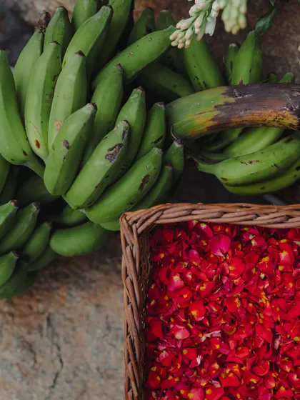 Traditional wedding elements like raw bananas and baskets of red rose petals, essential for South Indian rituals.