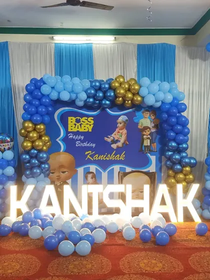 A classic Boss Baby theme for Kanishak's birthday. The blue and gold balloon arch, combined with a themed backdrop and light-up letters, creates a fun and formal look for the little boss.