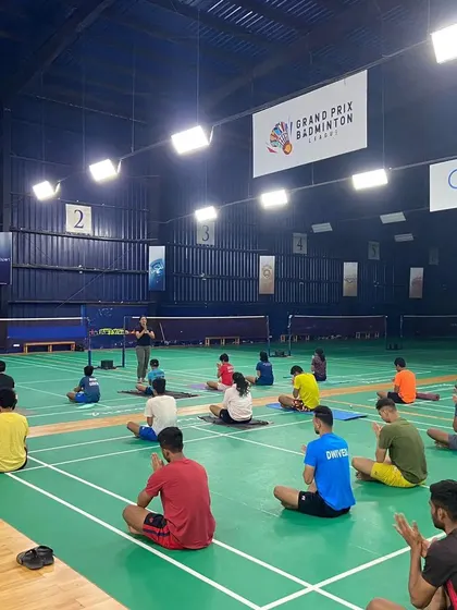 Athletes sit in a meditative posture at the start of a mindfulness session. This practice helps cultivate the concentration needed to stay present and focused during long and demanding matches.