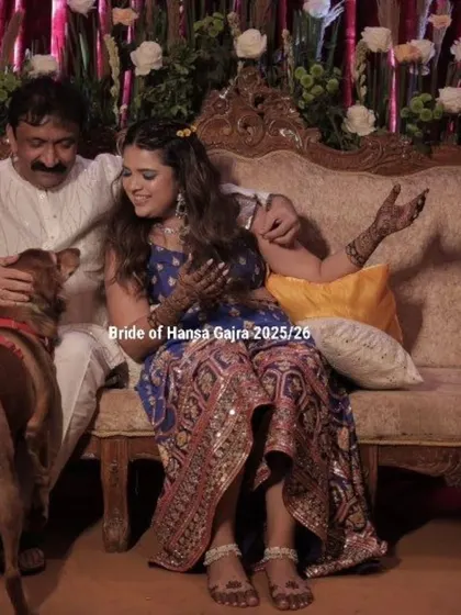 A candid moment from a mehendi ceremony, filled with joy, love, and even a furry friend. The bride's laughter and the relaxed atmosphere are what make these events so memorable.