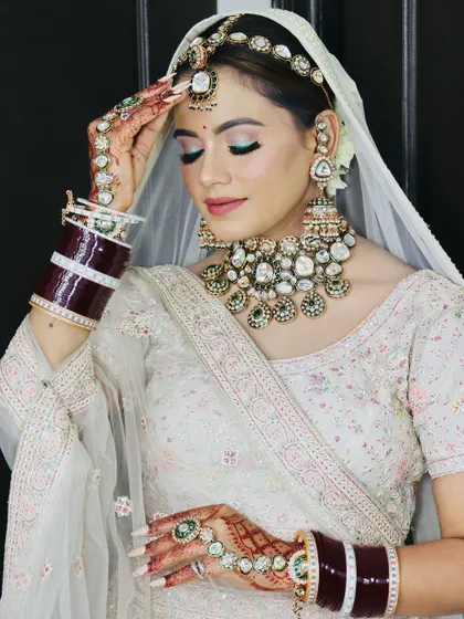 Another elegant pose, highlighting the intricate details of her outfit and makeup.