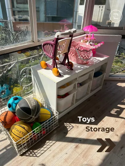 We created a dedicated toy storage area using open-front bins and baskets. This system allows kids to easily see and access their toys, like balls and outdoor gear, and makes cleanup time much faster.