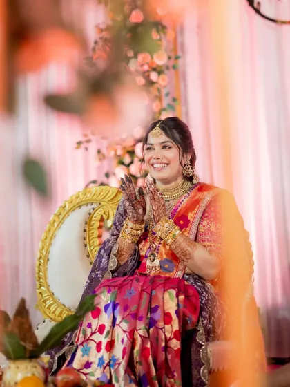 The joy and excitement of the wedding day are palpable in this photo. The bride's makeup is bright and celebratory, matching the festive atmosphere of the event.