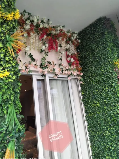A close-up of our floral canopy work over a balcony door. We use a mix of artificial flowers and vines, like bougainvillea and wisteria, to create a romantic and colorful entrance.