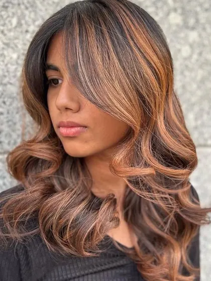 A stunning Bronde Balayage, the perfect blend of blonde and brunette hues. This technique adds dimension and texture for a sophisticated look.