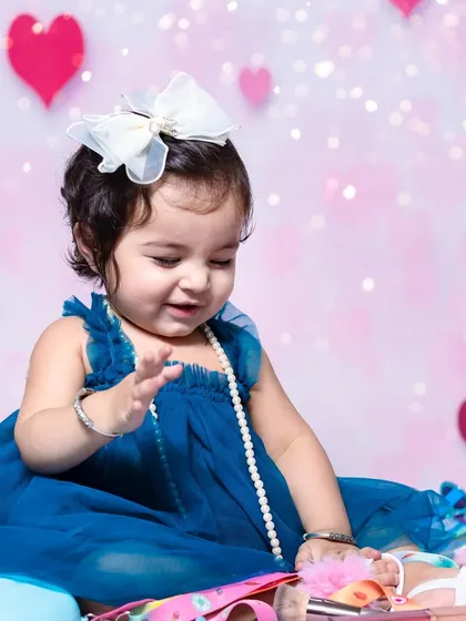 A sweet, candid moment as she plays with her accessories. I capture both posed and unposed shots to give you a full story.