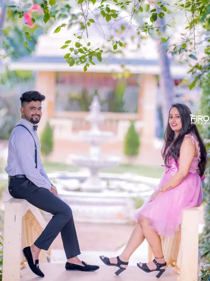 A relaxed and stylish portrait of a couple on a balcony. The soft, natural light and the garden background create a very serene and beautiful atmosphere.