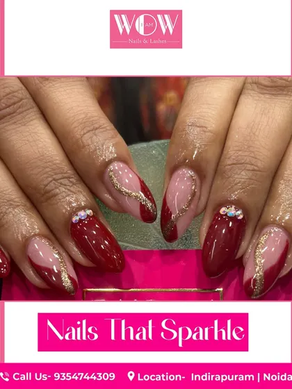 A sophisticated design in deep red, featuring sparkling gold glitter accents and delicate rhinestone details. This look is perfect for a special occasion.