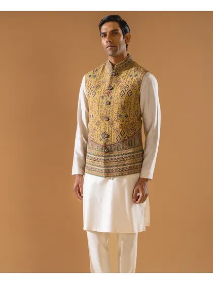 A full-length view of the mustard-yellow embroidered Jawahar jacket, showcasing its unique pattern and overt cuts. It is an essence of timeless elegance for the festive season.