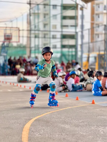 This young skater demonstrates perfect balance and posture as he navigates the course.