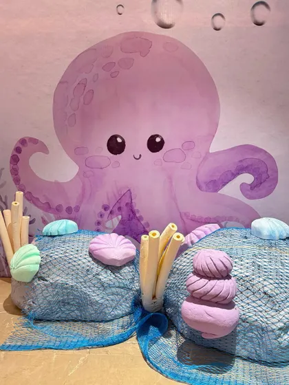 The details of our mermaid party included custom-designed treat boxes with seahorses and shells, and adorable octopus characters that added to the underwater fantasy.