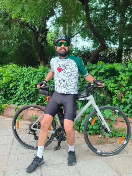Brotherhood on pedals. A rider posing with his bike, representing the shared strength and laughs of our crew.