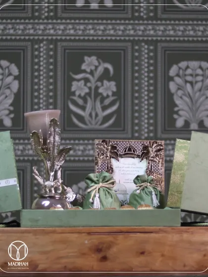 This complete wedding hamper set, with its silver decor, invitation frame, and gift boxes, is arranged on a wooden table, showcasing how every element comes together to create a cohesive and elegant statement.