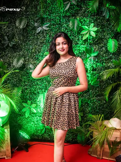 A guest posing against the tropical-themed backdrop at Roxy, Kolkata. The 'Havana Social' theme was a hit.