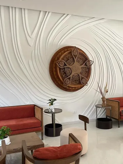 The completed masterpiece. This wide shot shows how the finished relief sculpture transforms the entire living area, creating a powerful and elegant focal point that feels like a natural extension of the architecture.