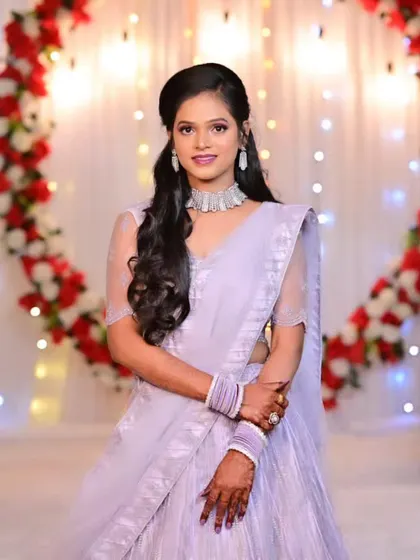A full-length portrait of the bride in her engagement lehenga, looking graceful and elegant.