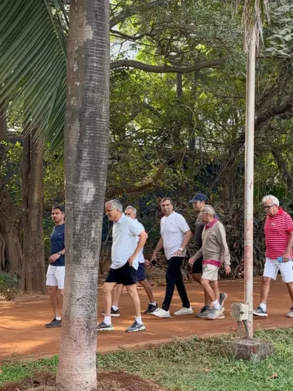 A group of men enjoying a morning walk along the park's jogging path. The park is a hub for people of all ages to stay active and healthy.