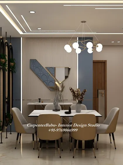 This dining area uses a dark blue accent wall and gold decorative wreaths to create a moody and luxurious atmosphere. The vertical partition adds a modern touch.