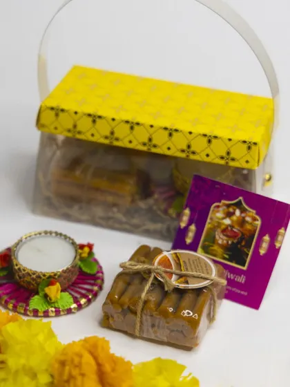 This lovely Diwali hamper comes in a basket-style box and contains a stack of our handmade Ubtan soaps, a decorative diya, and a festive wish card.