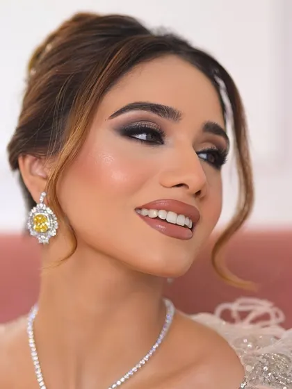 A close-up of the soft yet dramatic smokey eye, blended to perfection. The glowing skin and glossy nude lip complete this elegant look.