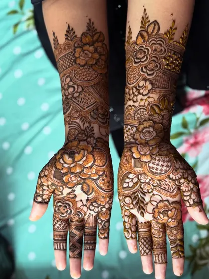 A lovely floral henna design for a party. It covers the hands beautifully, making it a great choice for guests who want something special.
